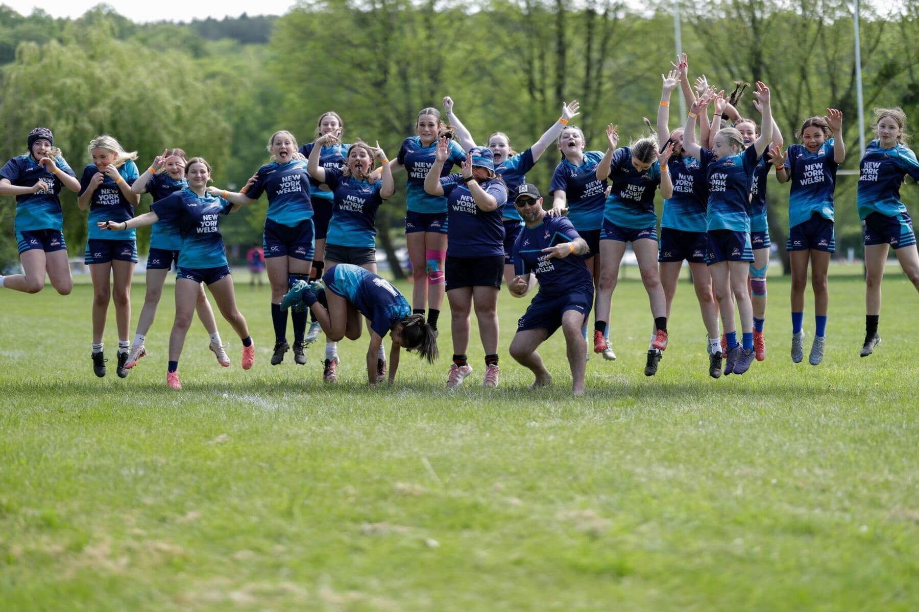 A team celebrating together on the pitch at a Revel Rugby festival